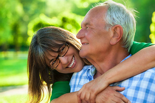 istock Senior couple hugging in park 476374837