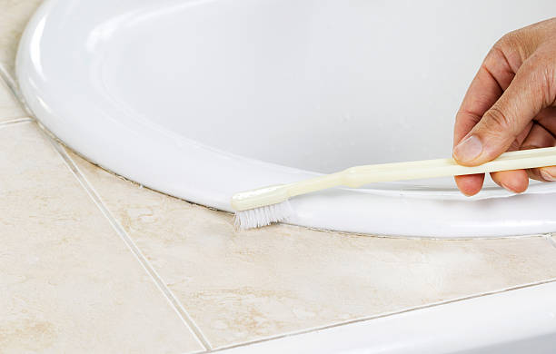 istock Cleaning Bathroom Sink with Tooth Brush 476375131