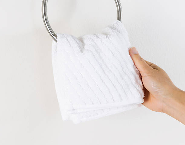istock Female hand hanging up small white wash cloth 476375151