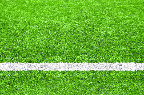istock White stripe on the green soccer field. 476375234