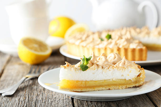 istock Lemon meringue pie on plate on grey wooden background 476375872