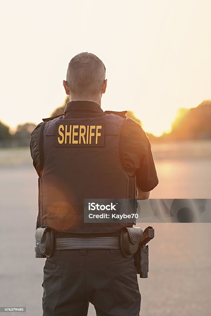 Comté de Shérif officier de Police au coucher du soleil - Photo de Shérif libre de droits