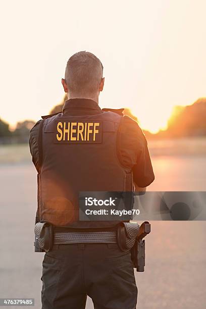 County Sheriff Police Officer At Sunset Stock Photo - Download Image Now - Sheriff, Police Force, Sunset