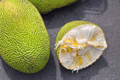 Jackfruit Whole and Open with Yellow Flesh for Sale at Outdoor Wet Market in Southeast Asia