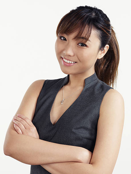 Asian business woman portrait arms crossed Asian business woman portrait arms crossed. sleeveless top stock pictures, royalty-free photos & images