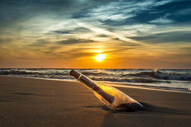 istock Ancient message with bottle in the sea 476383119