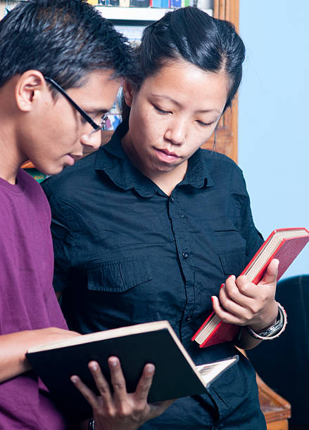 istock Highschool Boy and Girl Looking at Book 476383321