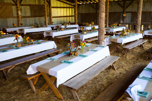 Overview of this wedding reception shows the tables ready for guests with organic natural decor and decorations.