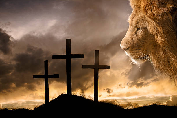 God's Victory at Calvary A brilliant sky illuminates the empty crosses on the day of Jesus' crucifixion. God, The Lion of Judah, overlooks the hill where His son Jesus died for sinners. self sacrifice stock pictures, royalty-free photos & images