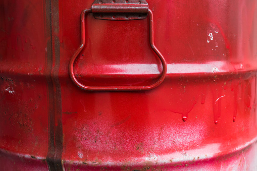 Extreme close up of a red barrel of oil.