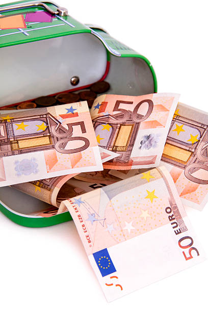 Fifty Euro Note Spilling Form Money Box stock photo