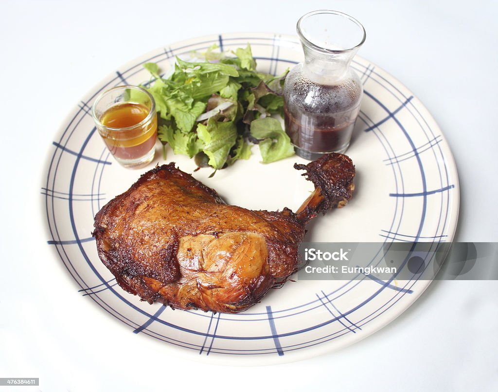 Roasted chicken on a plate Roasted chicken on a plate with sauce Brown Stock Photo