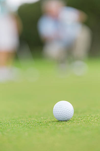 istock Close up of golf ball on green course during game 476386447