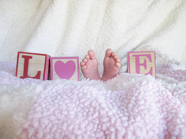 Little baby girl and a box with a gift on a white background.