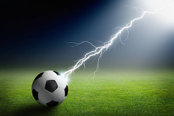 Soccer ball, lightning, spotlight stock photo