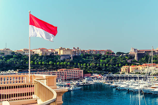 Monaco National flag of of the Principality of Monaco and view of port monte carlo photos stock pictures, royalty-free photos & images