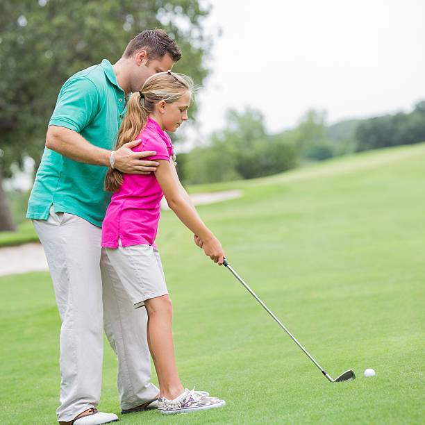 pai ensinando menina como equilibrar whle jogar golfe - golf golf swing putting cheerful imagens e fotografias de stock