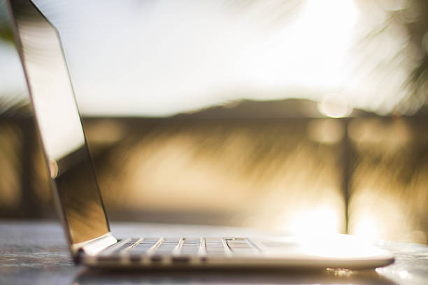 istock laptop on nature at sunrise 476399470