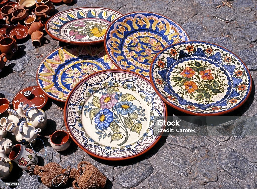 Ceramic plates on floor, Evora, Portugal. Decorative Ceramic plates and pots on floor, Evora, Alentejo Region, Portugal, Western Europe. Évora District Stock Photo