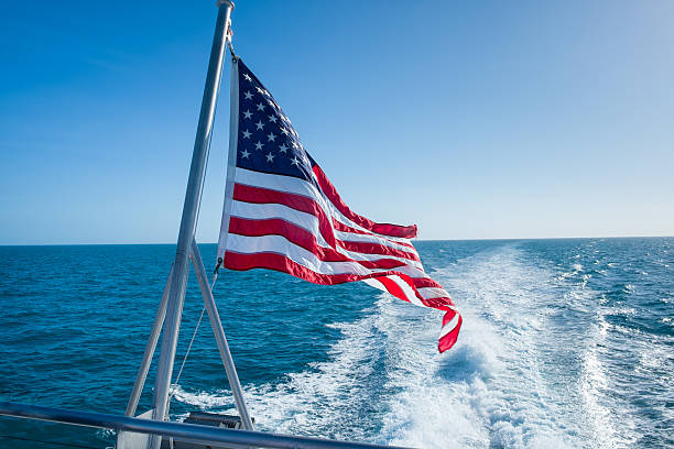USA Flag on Stern of Boat with Wake stock photo