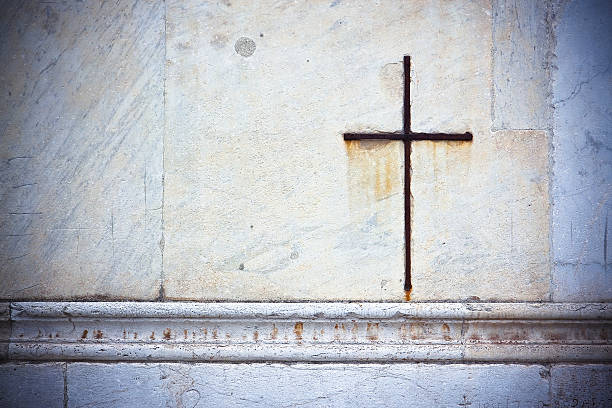 istock Iron cross snuggled in white stone 476408800