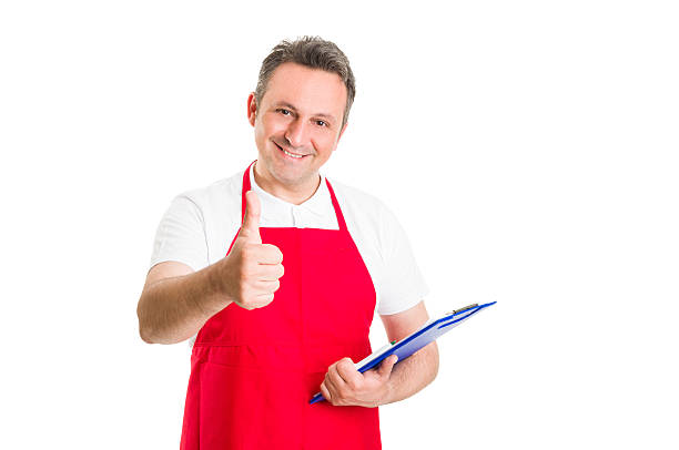 Friendly hypermarket employee holding clipboard and showing thumb up