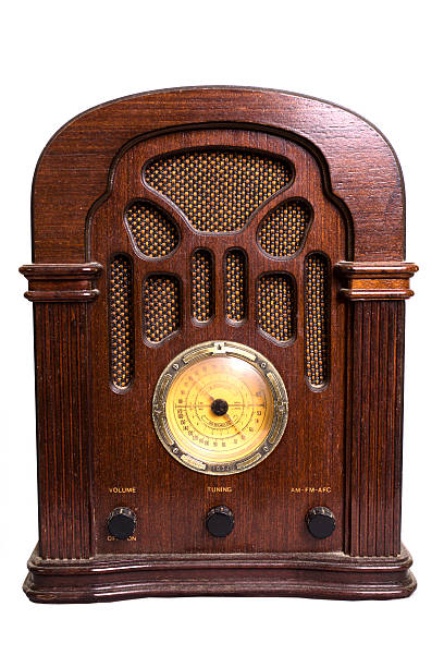Vintage radio from the 1930s isolated on white. Antique radio from the 1930s era.  Retro, vintage style equipment. The old fashioned radio is isolated on a white background and is made of wood. It has a speaker grille and tuning knobs on front.  radio broadcasting photos stock pictures, royalty-free photos & images