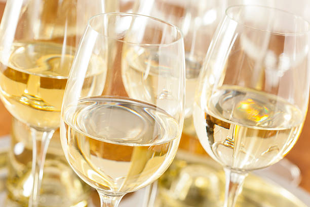 Refreshring White Wine in a Glass Refreshring White Wine in a Glass on a Background white wine photos stock pictures, royalty-free photos & images