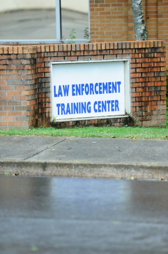 Sign for law enforcement training center with copy space below.