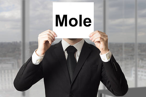 istock businessman hiding face behind sign mole 476422692
