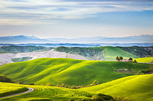 istock Tuscany spring, rolling hills on sunset. Volterra rural landscap 476423512