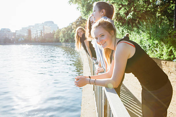 istock young women lean against a railing, on urban background 476428128