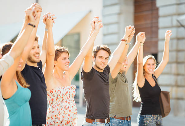 istock Group of friends with arms raised 476428556