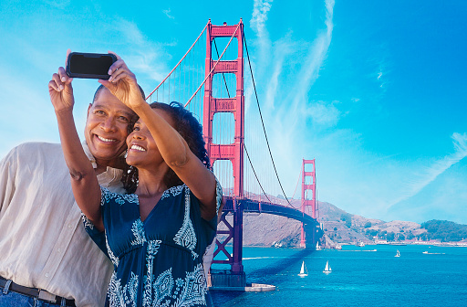 African American Couple taking a selfie at the Golden Gate Bridge in San Francisco.