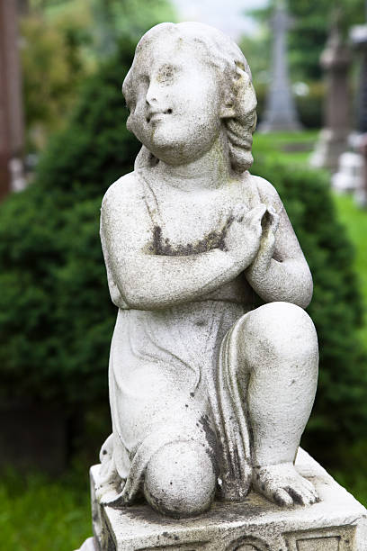 istock Tombstone statue of a young child 476430023
