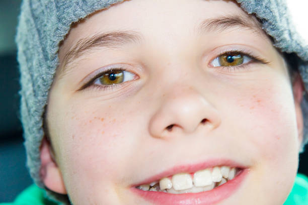 Sweet little girl in a outdoor shadowy portrait from the mouth up. Her eyes look up to the heavens. A blue, blue sky above her.