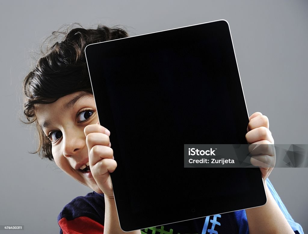 Cute little boy with Tablet PC Cute kid with Tablet Child Stock Photo