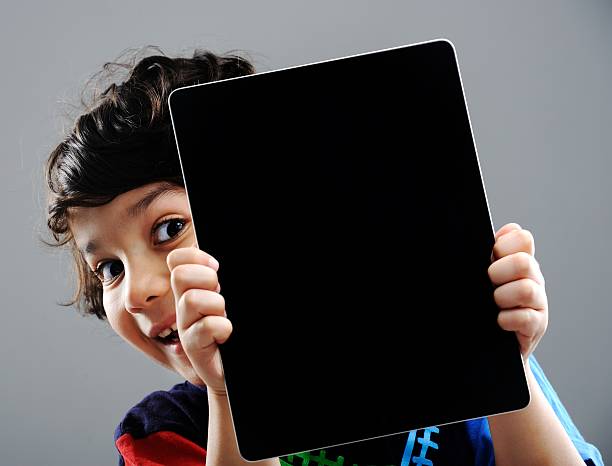 Cute little boy with Tablet PC stock photo
