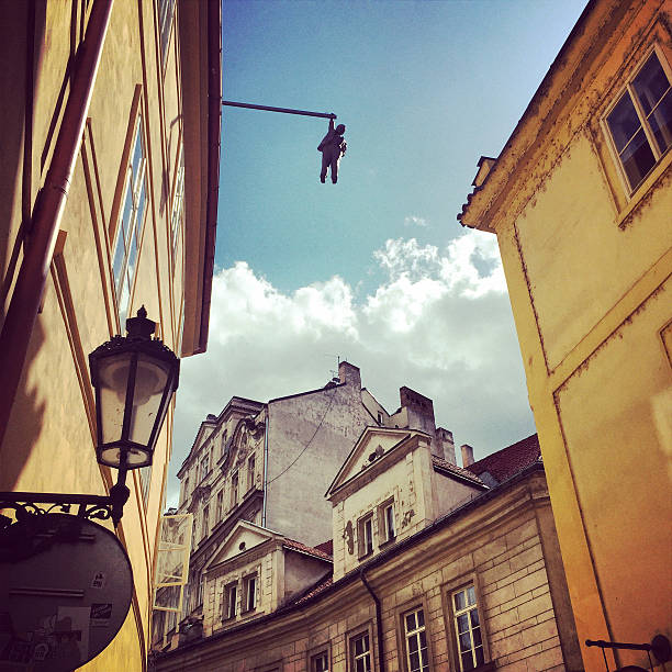Prague, Czech Republic  - May 7, 2015: Prague architecture with hanging Statue  of Zigmund Freud by David Černý