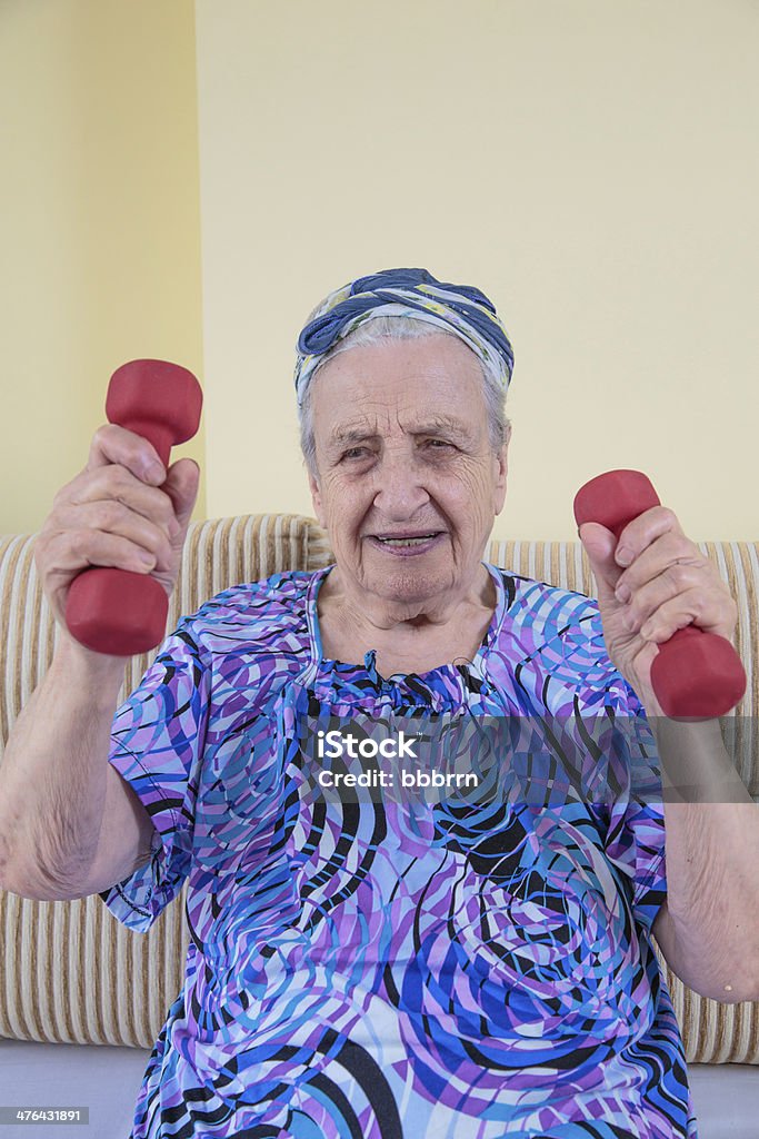 sportive woman senior woman exercising with dumbbells Active Lifestyle Stock Photo