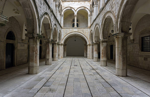 Columned, arched, gothic room. A Gothic looking chamber with columns, arches and a long entrance hallway. Main focus on central hallway. medieval architecture stock pictures, royalty-free photos & images