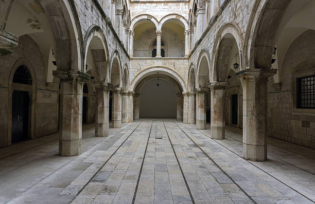 Columned, arched, gothic room. A Gothic looking chamber with columns, arches and a long entrance hallway.  Main focus on central hallway. turret arch stock pictures, royalty-free photos & images