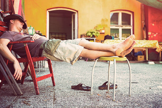 Lazy mid adult man sleeping on terrace during the day