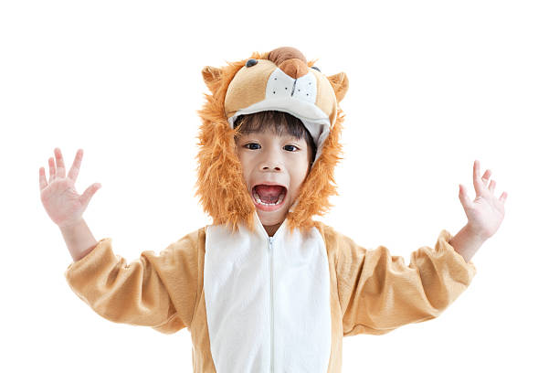 Cute little boy dressed in lion suit Llittle lovely asian boy trick or treat concept, lovely boy costumed and acting like a lion, isolated on white background costume stock pictures, royalty-free photos & images