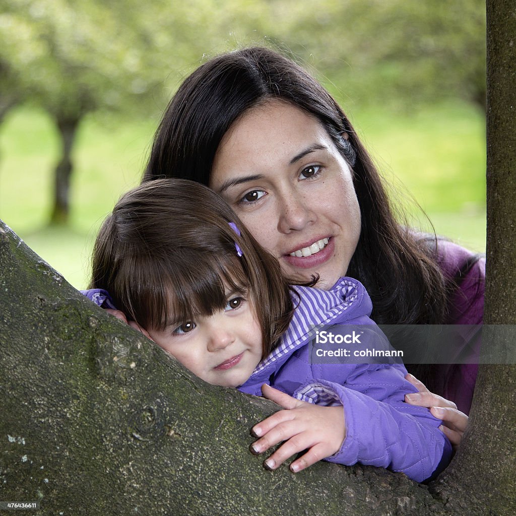 Mother and Daughter Cuddling as they Rest on a Tree Beautiful Mother and Daughter Resting on a Tree as they Enjoy Nature Aunt Stock Photo