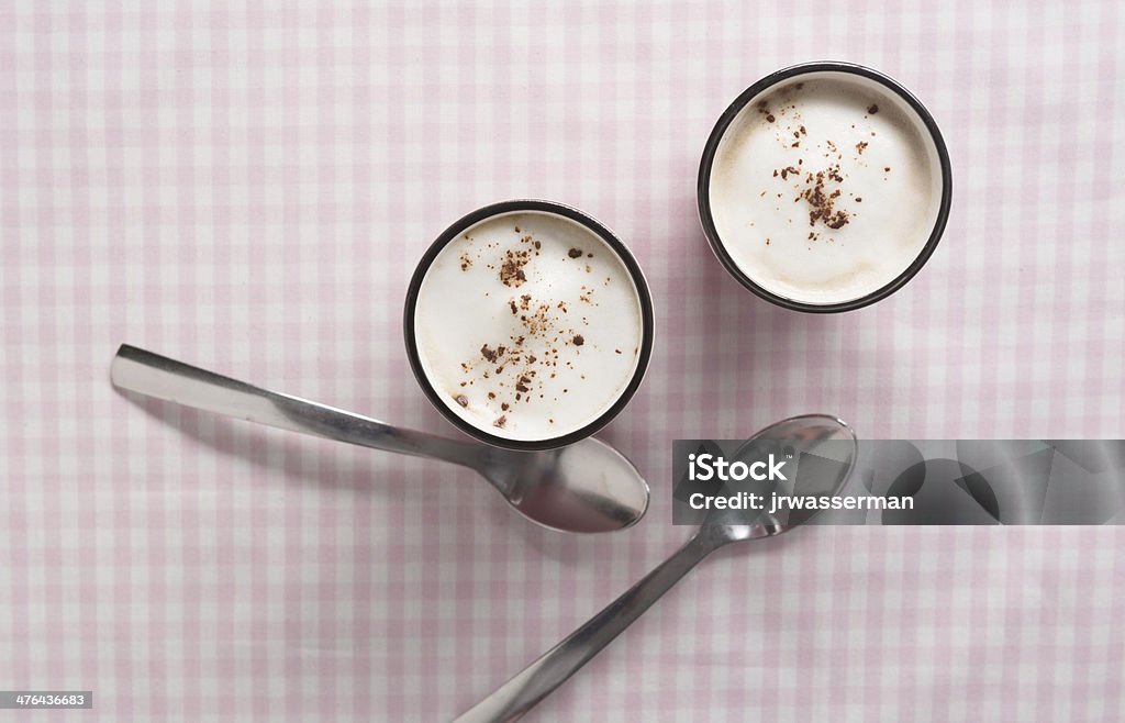 Cappuccino in Pink Mug with Almond Milk Foam Cappuccino in pink cup with cocoa and almond milk foam and spoons Breakfast Stock Photo
