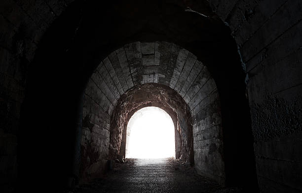 istock Glowing end of dark abandoned tunnel 476439245