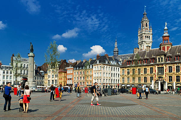 Lille Grand Place Lille, France - August 29, 2013: Lille Grand Place showing the Chamber of Commerce tower and the Vieille Borse with tourists walking across the main square and some traffic in the mid ground. historic building photos stock pictures, royalty-free photos & images
