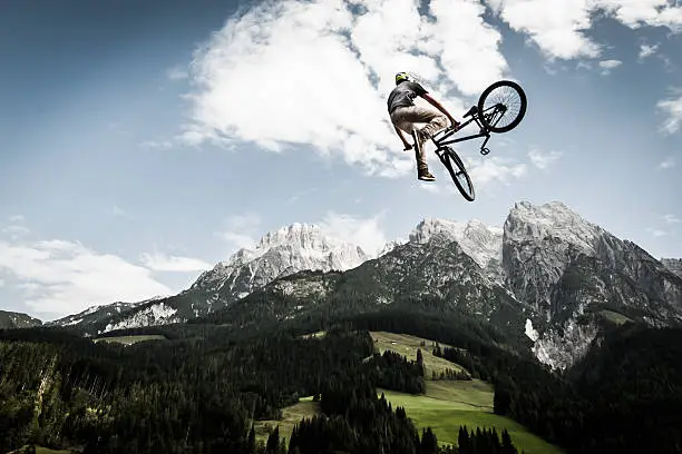 biker rotates his bike arround high in the air