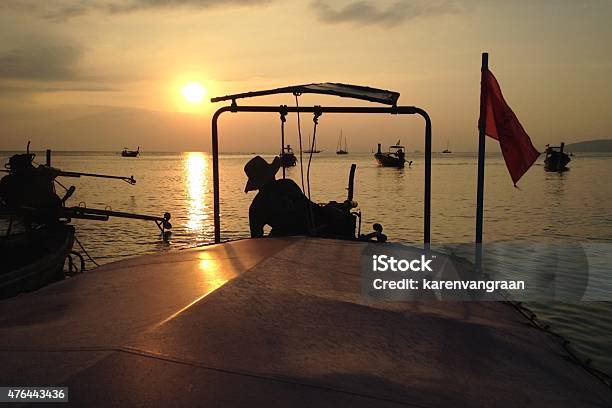 Longtail Boat Driver At Dusk In Krabi Thailand Stock Photo - Download Image Now - 2015, Adaman Sea, Ao Nang